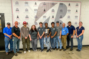 SEED Program: Students standing in front of a Bridgestone backdrop during a company visit.