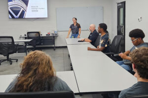 SEED Program: Students listening to a Bridgestone representative speak during tour.