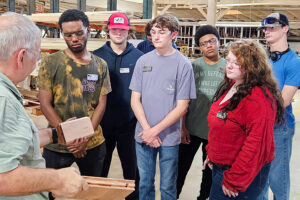 SEED Program: Group of students listening to a Stephenson Millwork representative during the tour.